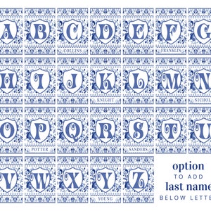 May include: A set of 26 alphabet tiles with blue and white Delft-inspired designs. Each tile features a letter in a shield shape with a floral pattern. The tiles are arranged in rows of four, with the last row having only three tiles. The last tile in the last row has the word "YOUNG" below the letter "Z".