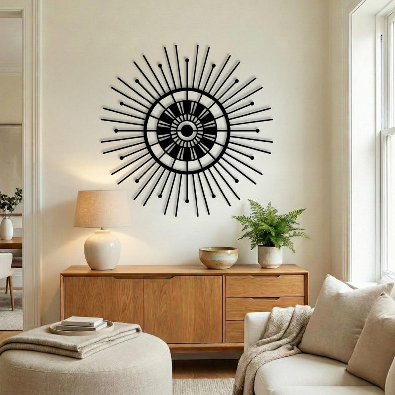 Black mid century modern sunburst sign, retro entryway wall art over light wood credenza.