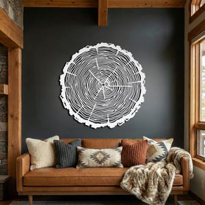 White wood grain metal decor, modern farmhouse focal piece on dark wall above leather couch