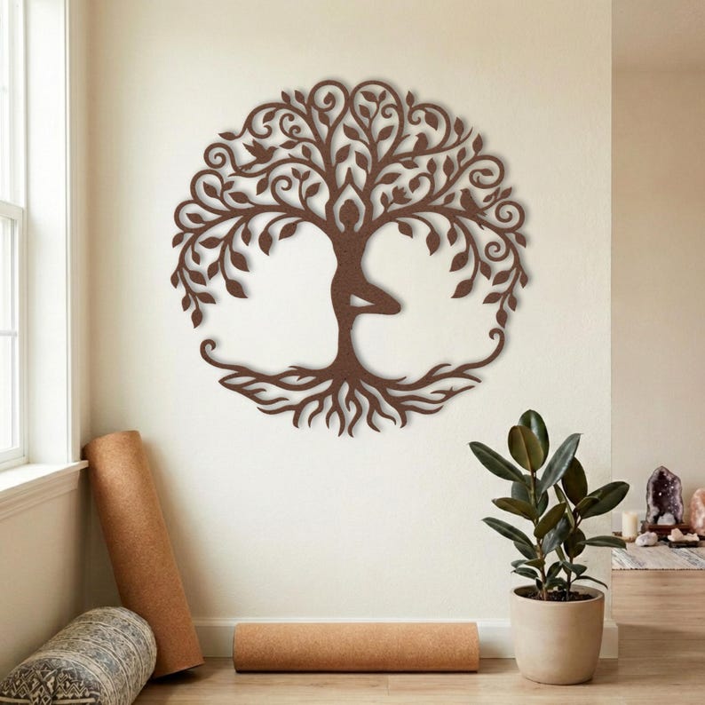 Tree pose metal wall art, yoga studio decor with rolled mats.