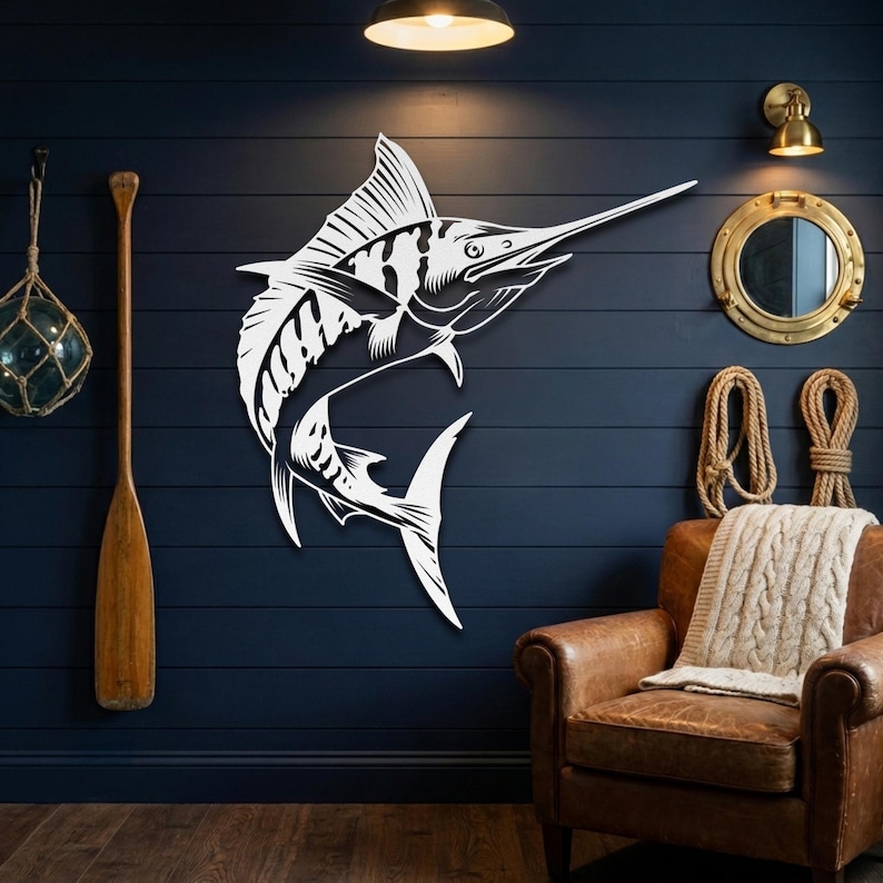 White metal marlin wall art mounted on a navy blue wall with nautical decor and brass lighting.