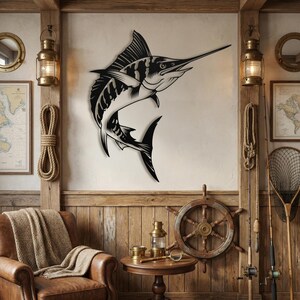 Black marlin silhouette sign hanging above a leather chair styled with vintage fishing rods and nets.