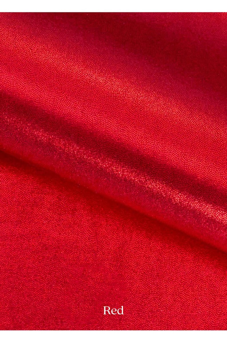 May include: Red fabric with a sparkly, textured surface. The fabric is folded in half, with the fold line visible in the center of the image. The word "Red" is printed in white at the bottom of the image.