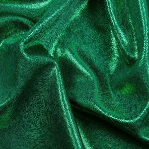 May include: Green iridescent fabric with a textured, sparkly finish. The fabric is wrinkled and folded.