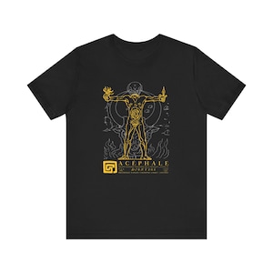 May include: Black t-shirt featuring a yellow illustration of a headless figure with outstretched arms, holding flames and knives. The design includes the text "ACEPHALE DIONYSOS" and a stylized "G" symbol.