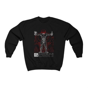 May include: Black sweatshirt with a white graphic of a headless human figure with internal organs visible. The graphic is surrounded by flames and the text "ACEPHALE  DIONYSOS" in red.