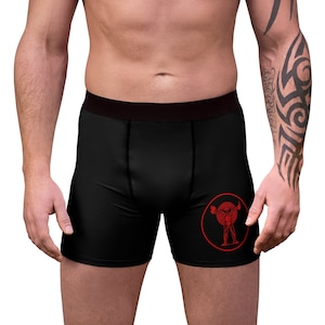 May include: Black boxer briefs with a red circle graphic of a stylized human figure.