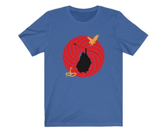 May include: A royal blue t-shirt with a red and white spiral design. A silhouette of a person holding a staff with a bird flying above and a snake below.