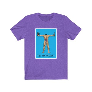 May include: Purple t-shirt with a blue and white illustration of a person with their arms outstretched. The illustration is surrounded by a white border and the text "THE SOCIOLOGIST" is below the illustration.