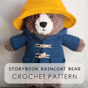 May include: A brown crocheted bear wearing a yellow hat and a blue duffle coat with two wooden toggles. The bear has a white muzzle and black eyes. Text on the image reads: STORYBOOK RAINCOAT BEAR CROCHET PATTERN. The bear is made of yarn.