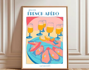 May include: A framed art print with the text "Give me, FRENCH APÉRO" in blue. The illustration features champagne glasses, oysters, and other aperitif items in a colorful, stylized design. The words "EDITION 2025" are at the bottom.