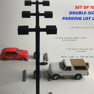 May include: Set of 10 double-sided parking lot lights. Each black light is 128 mm tall. Includes 20 grey parking wheel stops. The image also shows a red car and a white and tan truck. Text on the image reads "SET OF 10 DOUBLE-SIDED PARKING LOT LIGHTS."