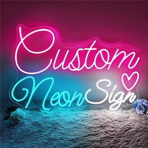 May include: A neon sign with the words "Custom Neon Sign" in white and pink script. The sign has a heart symbol and is set against a gradient background of pink and blue. Decorative flowers are at the bottom.