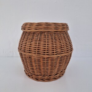 May include: A brown wicker basket with a round shape and a woven pattern.