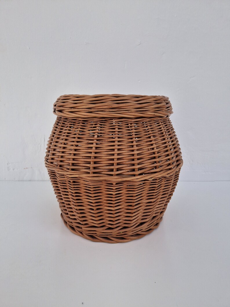 May include: A brown wicker basket with a round shape and a woven pattern.