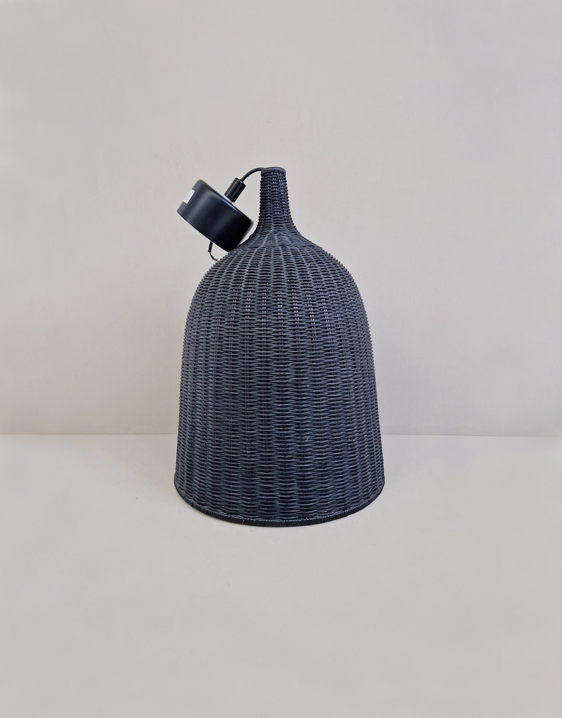 May include: A black woven pendant light fixture with a bell-shaped shade.