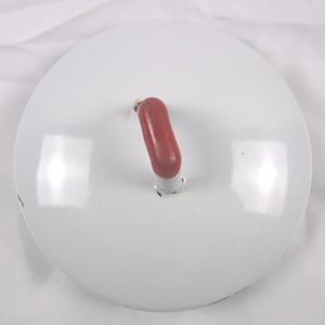 May include: A white, round lid with a red, oblong handle. The lid has a glossy finish and a small hole where the handle is attached. The handle is a solid, rounded shape, and the lid appears to be made of metal.