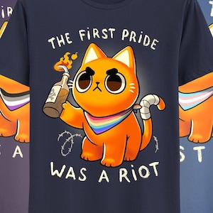 May include: Five t-shirts with a graphic of a cartoon cat holding a Molotov cocktail. The text on the shirts reads "The First Pride Was A Riot" and "The System Was A Riot".