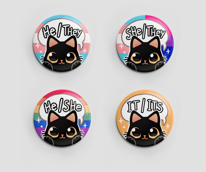 Puede incluir: Cuatro botones redondos con ilustraciones de gatos negros y diferentes combinaciones de pronombres. Los botones presentan un dise&ntilde;o de bandera arco&iacute;ris, transg&eacute;nero, bisexual y de g&eacute;nero neutro.