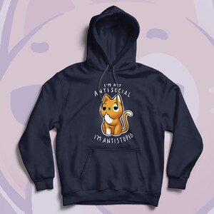 May include: Navy blue hoodie featuring a cartoon cat with the text "I'M NOT ANTISOCIAL I'M ANTISTUPID". The cat is orange and white with a slightly grumpy expression. The hoodie has a drawstring hood and a front pocket.