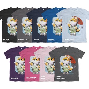 May include: A collection of t-shirts in various colors, including black, charcoal, navy, royal, and light blue. Each shirt features a cartoon Shiba Inu character wearing a kimono and holding a parasol. The shirts are labeled with their respective color names.