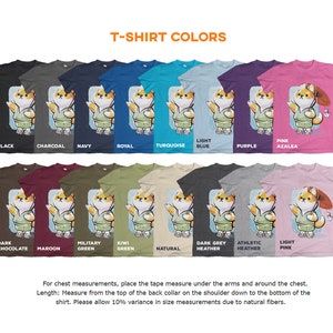 May include: A chart showing 16 different t-shirt colors with a cartoon Shiba Inu wearing a kimono on each shirt. The colors include black, charcoal, navy, royal, turquoise, light blue, purple, pink azalea, dark chocolate, maroon, military green, kiwi green, natural, dark grey heather, athletic heather, and light pink.