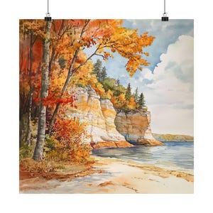 May include: A watercolor painting of a cliffside scene with fall foliage. The cliff is a light brown color with a sandy beach in the foreground. The water is a light blue color and the sky is a light blue with white clouds.