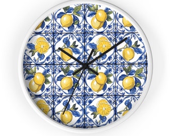 May include: White round clock with a blue and white tiled design featuring lemons and green leaves. The clock face is white with black hands.