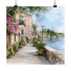 May include: A scenic watercolor print of a European coastal town. The artwork depicts a stone walkway lined with potted plants, leading to a building with a balcony. Pink flowers cascade from above. A lamppost stands near the water's edge, with a view of the sea and distant trees.