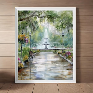 May include: Watercolor painting of a park scene with a tiered fountain, benches, and lampposts. The artwork features a pathway leading to the fountain, surrounded by lush greenery and colorful flowers. The painting is framed in a white border.