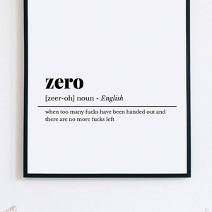 May include: Black framed print with the word "zero" and its pronunciation, along with a definition: "when too many fucks have been handed out and there are no more fucks left."