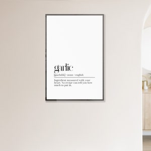 May include: Black and white printable wall art with the word "garlic" defined as an ingredient measured with your heart. The text reads "Ingredient measured with your heart. No recipe can tell you how much to put in."