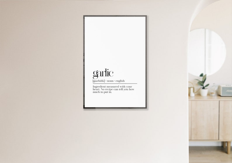 May include: Black and white printable wall art with the word "garlic" defined as an ingredient measured with your heart. The text reads "Ingredient measured with your heart. No recipe can tell you how much to put in."