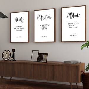 May include: Three framed motivational quotes with a wood frame. The quotes are: "Ability is what you're capable of doing", "Motivation determines what you do", and "Attitude determines how well you do it".