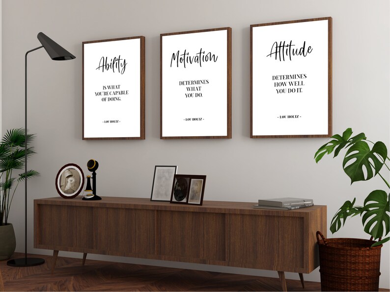 May include: Three framed motivational quotes with a wood frame. The quotes are: "Ability is what you're capable of doing", "Motivation determines what you do", and "Attitude determines how well you do it".