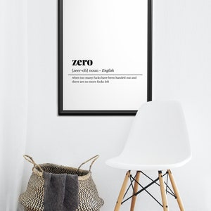 May include: A framed black and white print with the definition of "zero". The definition reads "when too many fucks have been handed out and there are no more fucks left". A white chair and a woven basket are also in the image.