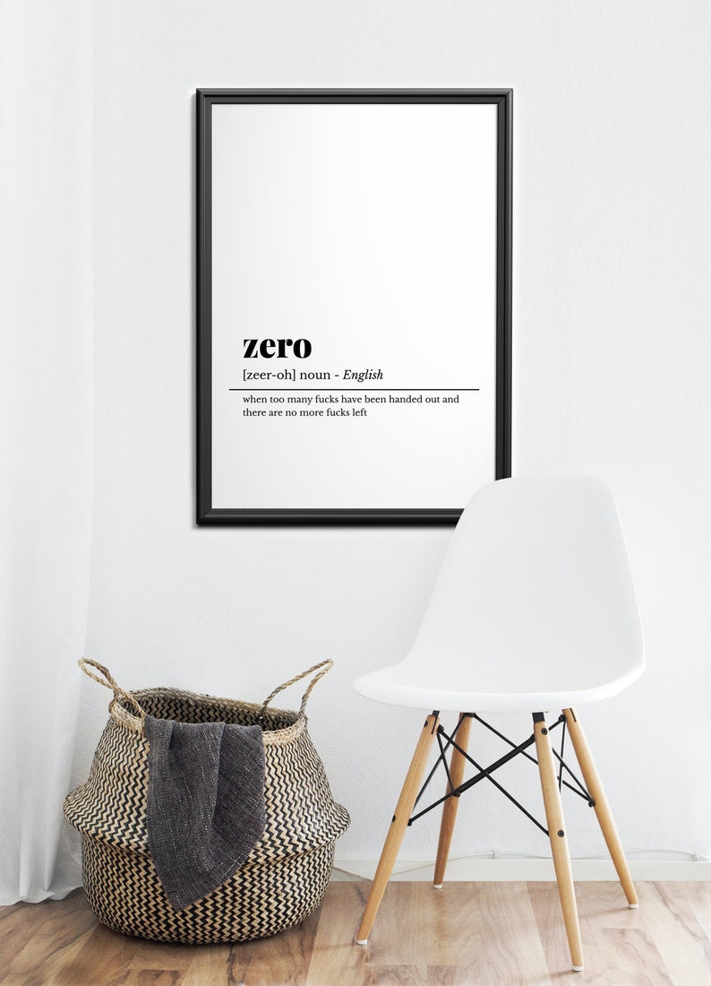 May include: A framed black and white print with the definition of "zero". The definition reads "when too many fucks have been handed out and there are no more fucks left". A white chair and a woven basket are also in the image.