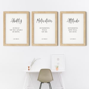May include: Three framed motivational quotes with a wood frame. The quotes are: "Ability is what you're capable of doing." "Motivation determines what you do." "Attitude determines how well you do it." Each quote is attributed to Lou Holtz.