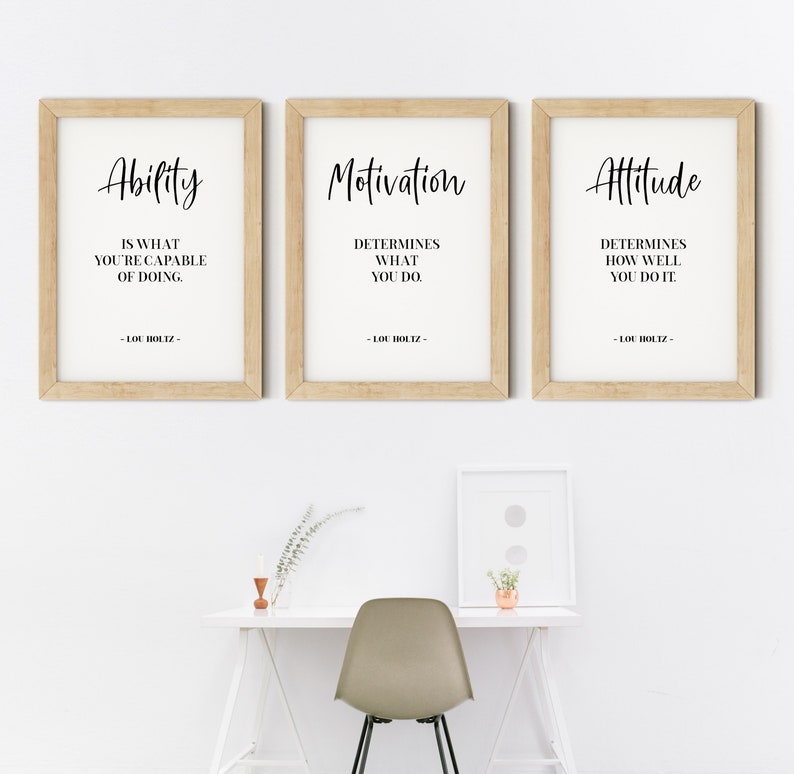 May include: Three framed motivational quotes with a wood frame. The quotes are: "Ability is what you're capable of doing." "Motivation determines what you do." "Attitude determines how well you do it." Each quote is attributed to Lou Holtz.