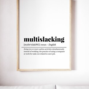 May include: A framed print with a definition of the word "multislacking" in black text on a white background. The definition is: "[məltē'slakiNG] noun - English doing two or more useless activities simultaneously instead of working. the practice of using a computer at work for tasks not related to one's job."