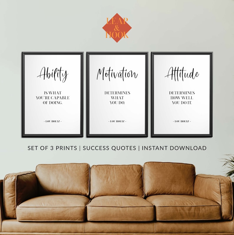 May include: A set of three black framed prints with white backgrounds and black text. The prints feature motivational quotes about ability, motivation, and attitude. The quotes are attributed to Lou Holtz. The prints are arranged in a row on a wall above a brown leather sofa.