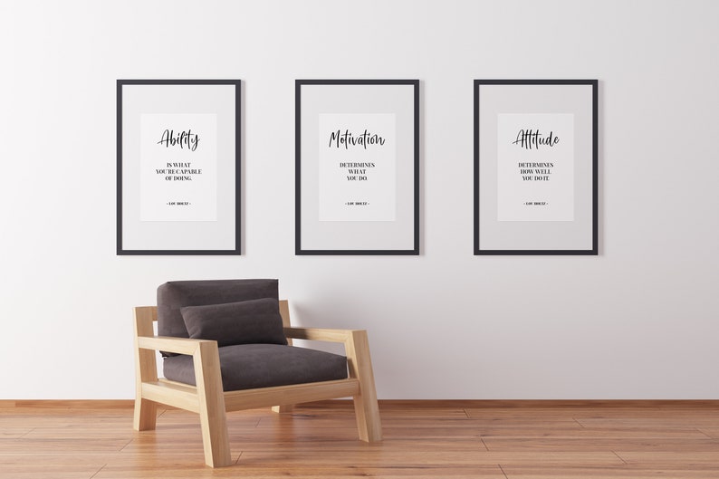 May include: Three black framed motivational posters with white backgrounds and black text. The posters are hung on a white wall. The text on the posters reads "Ability is what you're capable of doing. Motivation determines what you do. Attitude determines how well you do it."