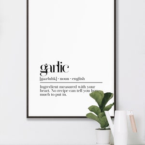 May include: Black and white printable wall art with the definition of the word "garlic". The definition reads: "[gaa-luhk] noun english Ingredient measured with your heart. No recipe can tell you how much to put in."
