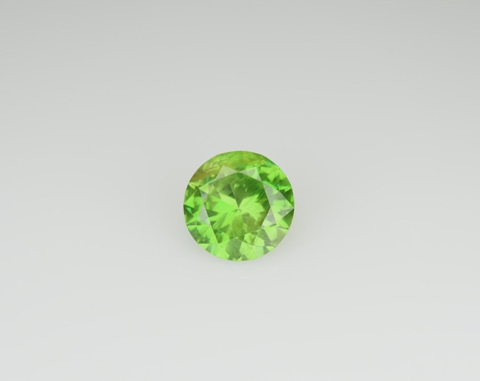 Lab-Certified, Russian Origin, .61 Carat, Round Cut, Demantoid Garnet with RARE Horsetail Inclusions