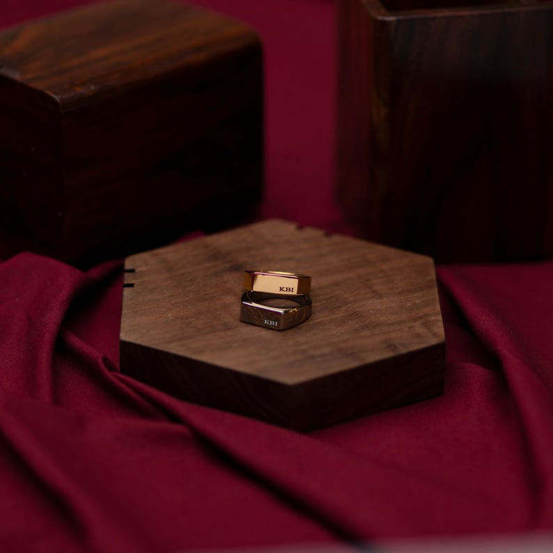 a wooden box sitting on top of a red cloth