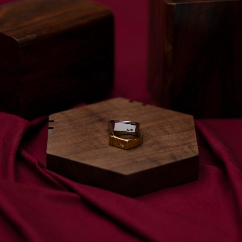 a wooden box sitting on top of a red cloth