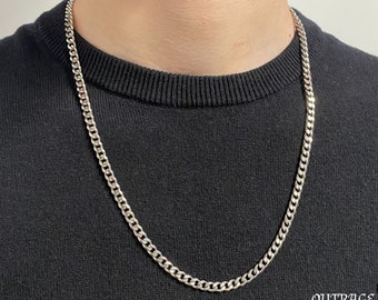 May include: A silver curb chain necklace. The chain is about 20 inches long and has a classic curb link design.
