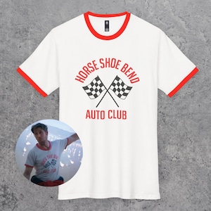 May include: White t-shirt with red trim. The front displays the text "HORSE SHOE BEND AUTO CLUB" above two crossed checkered flags. A circular image of a person wearing the same shirt is in the lower left corner.