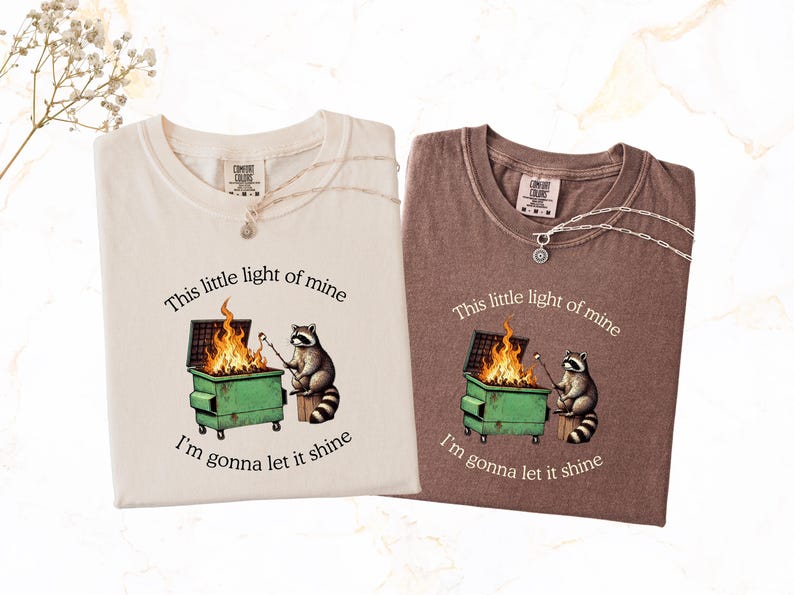 funny dumpster fire shirt, dumpster fire raccoon shirt, raccoon dumpster fire meme tee, trash panda shirt, funny raccoon graphic tee, this little light of mine parody shirt, chaotic raccoon shirt, anxiety humor shirt, funny meme t shirt, roasting marshmallow raccoon tee, comfort colors funny shirt, ironic humor tee, relatable humor shirt, chaos meme shirt, funny animal meme shirt, satirical graphic tee, unhinged raccoon tee, funny gift shirt, mental health meme tee, sarcastic tee, viral shirt