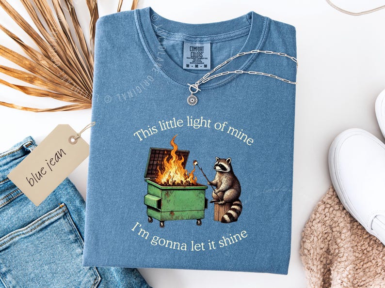 funny dumpster fire shirt, dumpster fire raccoon shirt, raccoon dumpster fire meme tee, trash panda shirt, funny raccoon graphic tee, this little light of mine parody shirt, chaotic raccoon shirt, anxiety humor shirt, funny meme t shirt, roasting marshmallow raccoon tee, comfort colors funny shirt, ironic humor tee, relatable humor shirt, chaos meme shirt, funny animal meme shirt, satirical graphic tee, unhinged raccoon tee, funny gift shirt, mental health meme tee, sarcastic tee, viral shirt